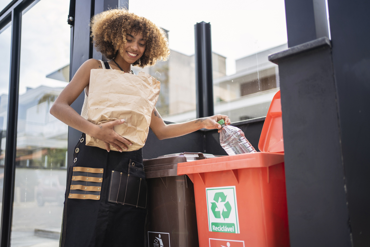 African american young woman recycling garbage. Sustainability concept.
